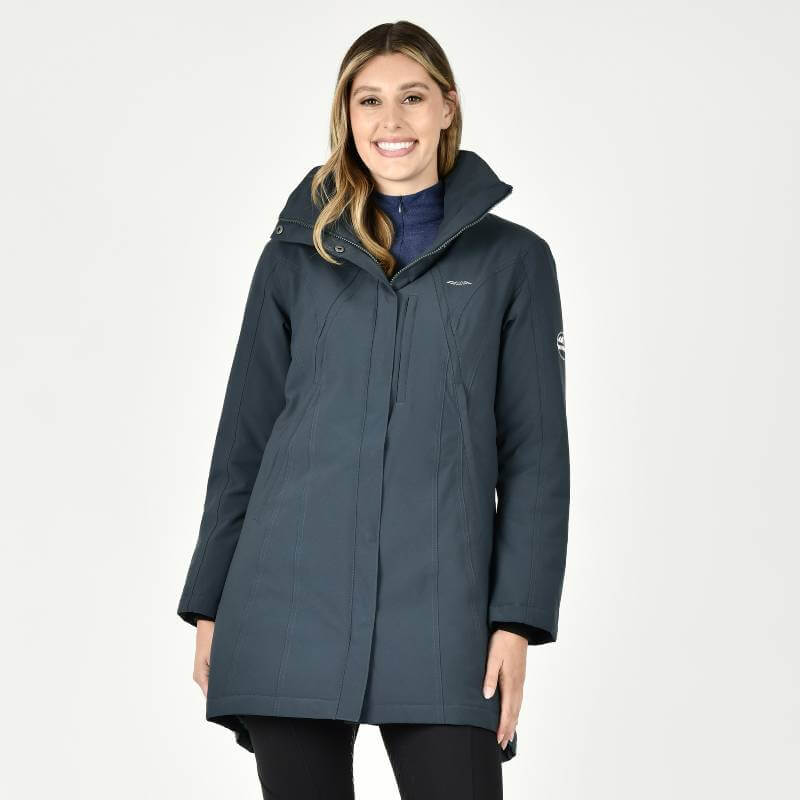 Woman in Weatherbeeta Kyla Waterproof Jacket Pine, standing and smiling against a white background.