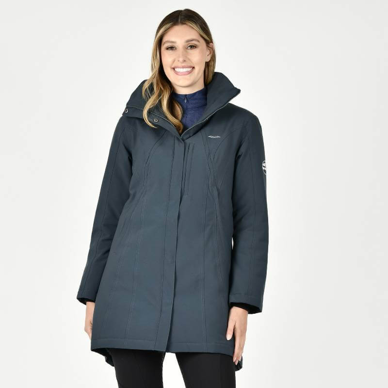 Woman smiling in a Weatherbeeta Kyla Waterproof Jacket Pine against a plain white background.