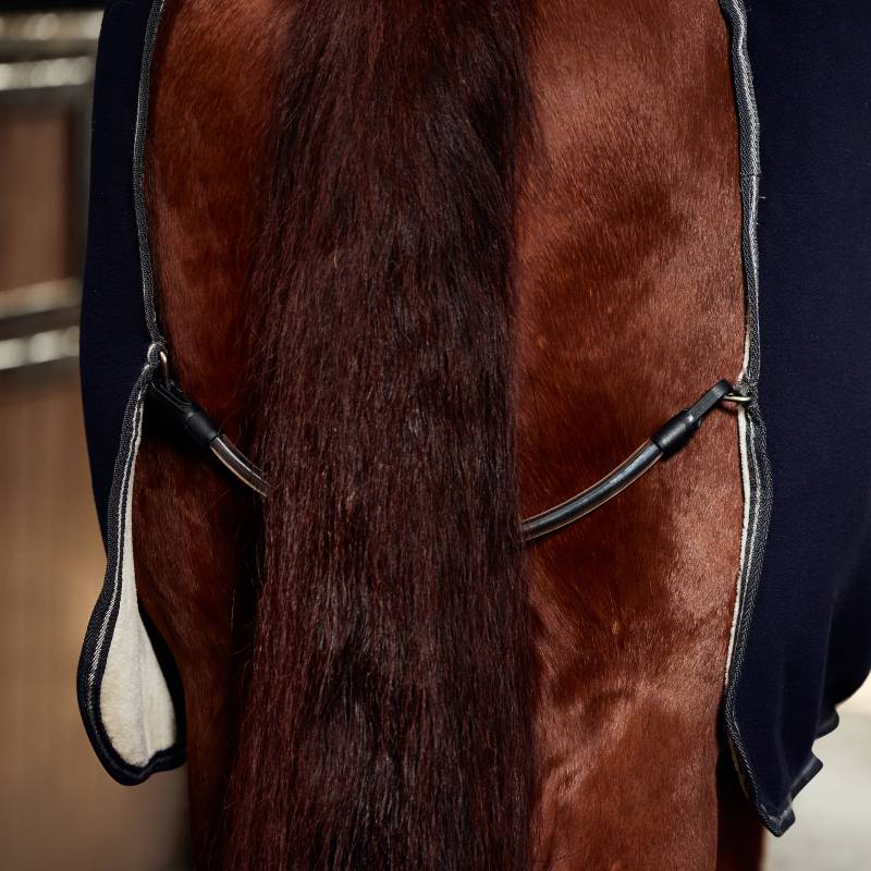 Close-up of a horse’s back with a dark brown tail and a Weatherbeeta Sherpa Fleece Cooler in navy.