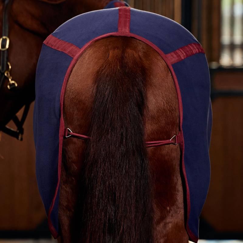 A horse wears a Weatherbeeta Anti-Static Fleece Cooler Standard Neck in navy/burgundy.