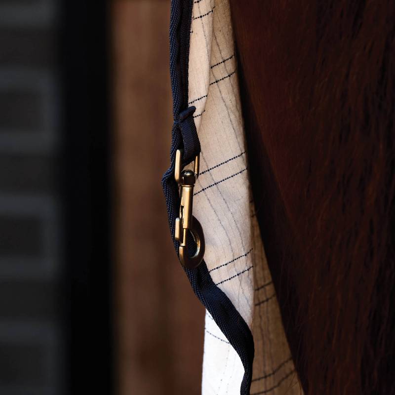 Close-up of a Weatherbeeta Comfitec Cotton Sheet Liner White/Navy on a brown horse.
