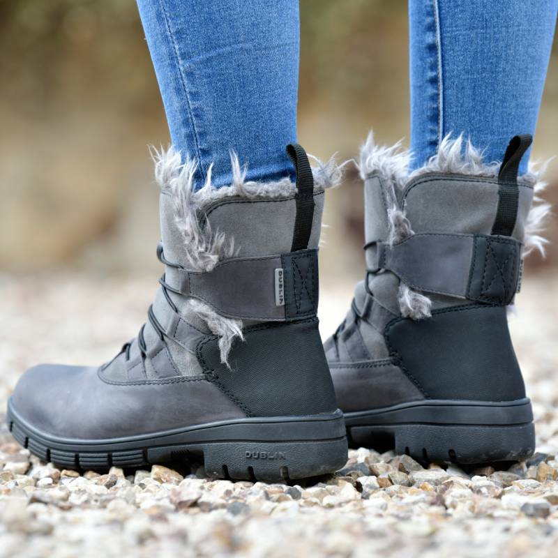 Wearing Dublin Boyne Boots Grey Adult with blue jeans, standing on gravel.