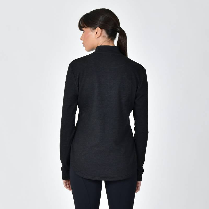 Woman wears Weatherbeeta London Layer Long Sleeve Top Black Marle, seen from behind.
