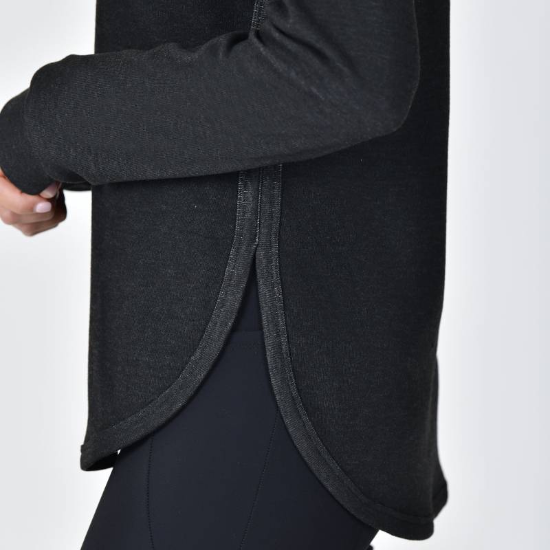 Wearing a Weatherbeeta London Layer Long Sleeve Top in Black Marle, side view.
