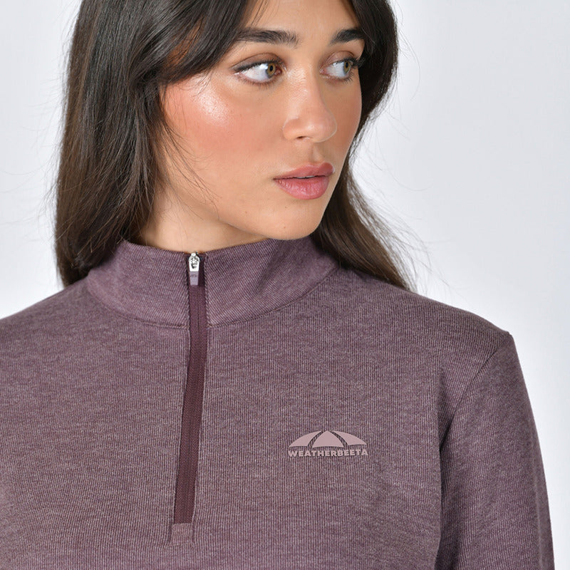 Woman in a mulberry marle Weatherbeeta London Layer Long Sleeve Top, looking left.