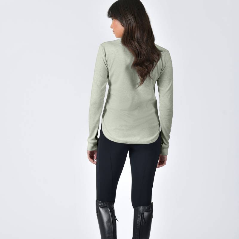Woman facing away in a Weatherbeeta London Layer Long Sleeve Top Olive Marle, black pants, boots.
