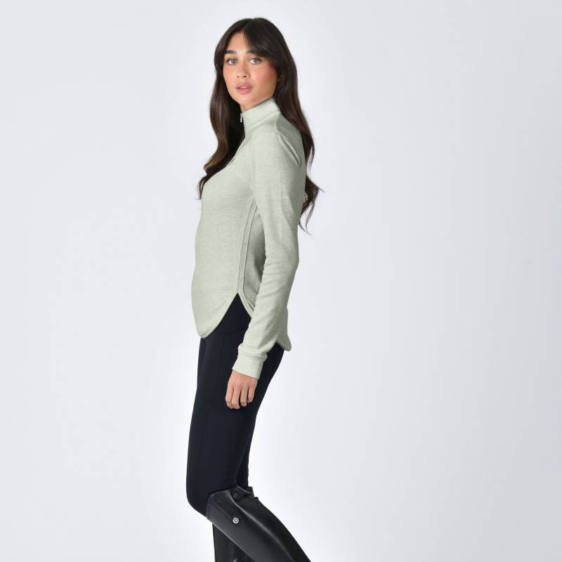 Woman in an olive marle Weatherbeeta London Layer Long Sleeve Top and black pants stands sideways.