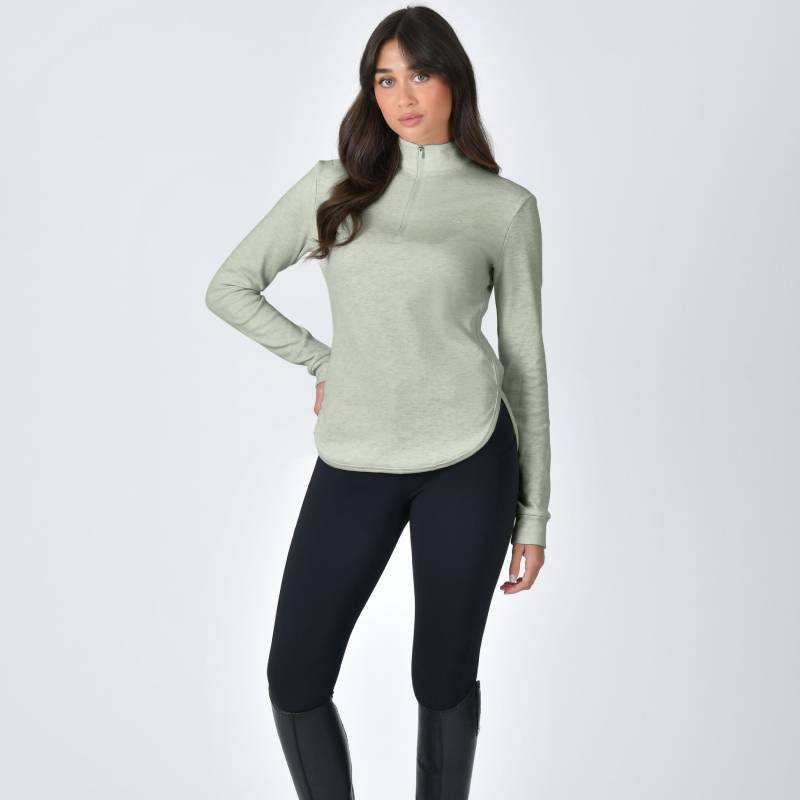 Woman in an olive marle Weatherbeeta London Layer Long Sleeve Top and black leggings, standing.