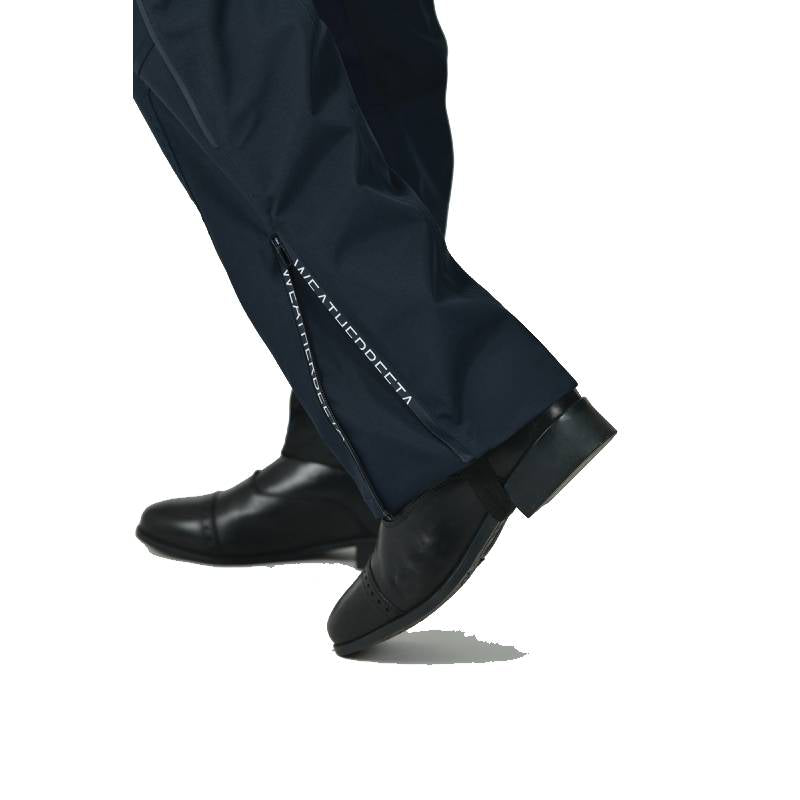 Weatherbeeta Rayne Waterproof Overtrousers II in navy/white, worn over black dress shoes.