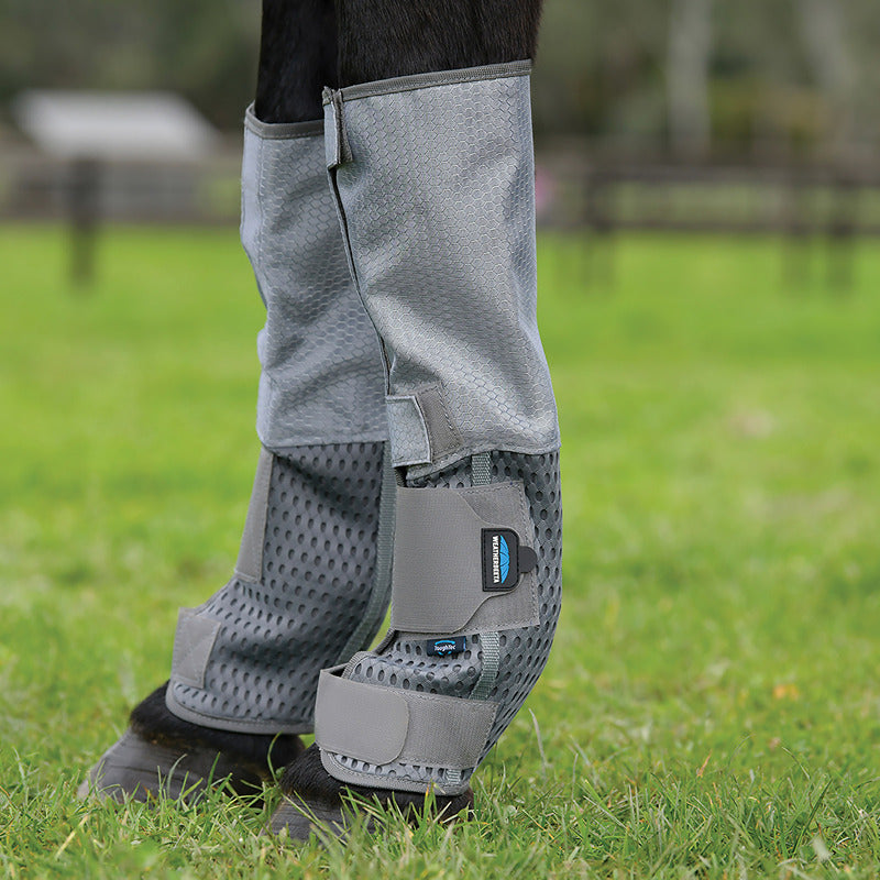 Close-up of Weatherbeeta Comfitec Hexi Shield Fly Wraps Grey/Silver on horse legs, green grass.