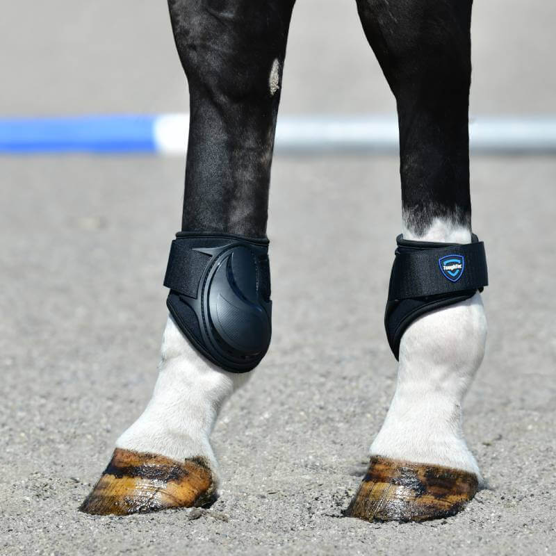 Close-up of Weatherbeeta Tough-Tec Essential Fetlock Boots Black on a horse on sand.