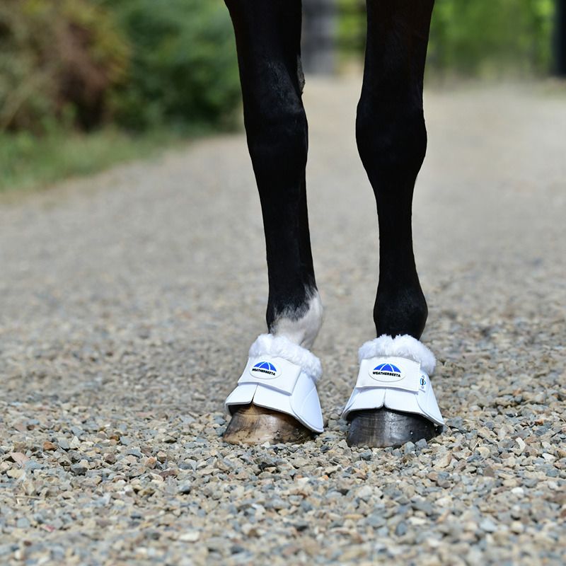 Weatherbeeta Tough-Tec fleece trim bell boots in white offer superior hoof protection.