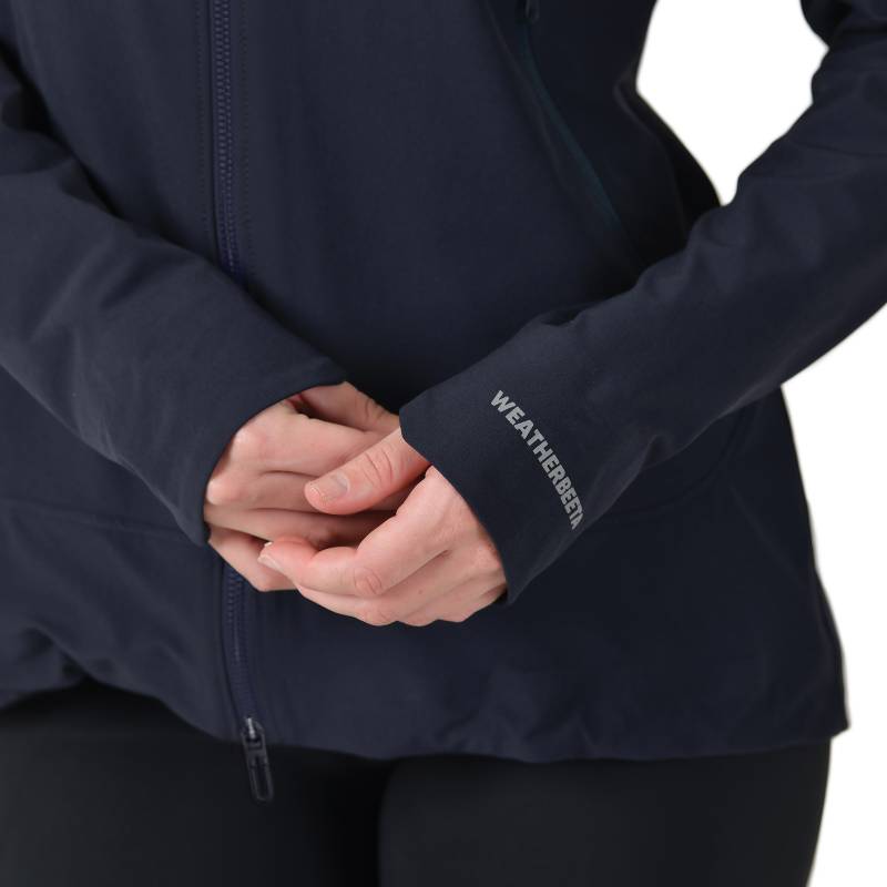 Person in a navy Weatherbeeta Abrasion Proof Stretch Riding Jacket, hands clasped.