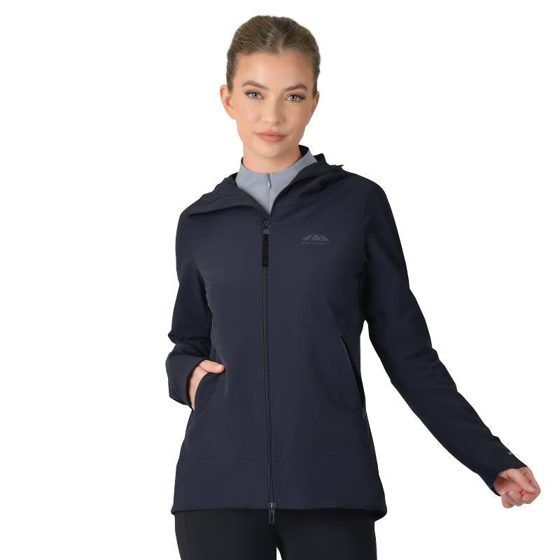 Woman in a Weatherbeeta navy abrasion proof stretch riding jacket, hands in pockets.
