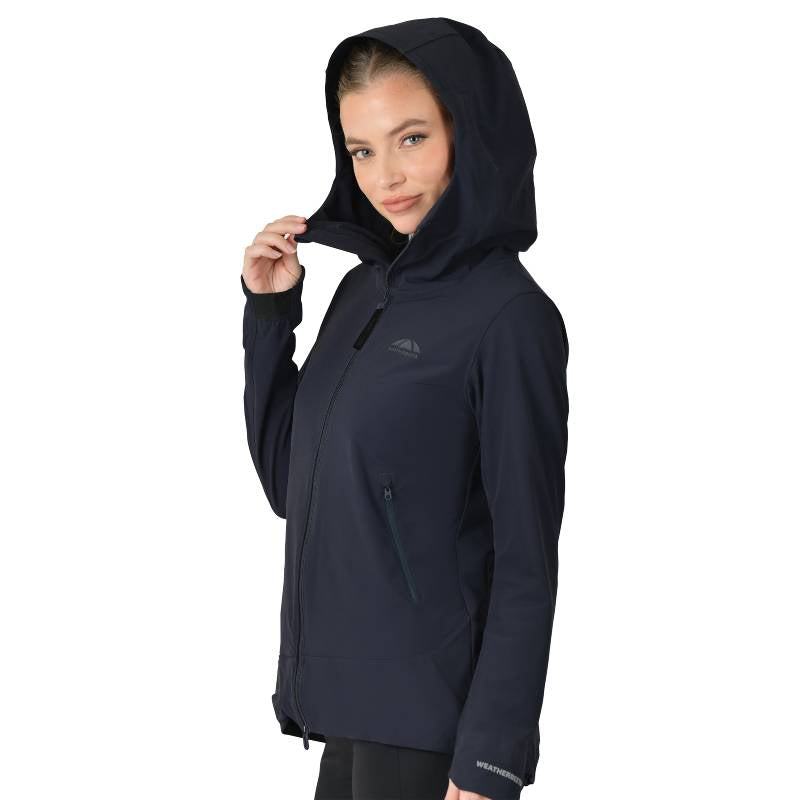 Woman in a Weatherbeeta Abrasion Proof Stretch Riding Jacket Navy, smiling and holding the hood.