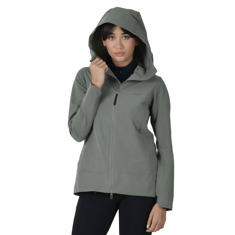 Woman in a Weatherbeeta Abrasion Proof Stretch Riding Jacket Olive Leaf, facing forward holding hood.