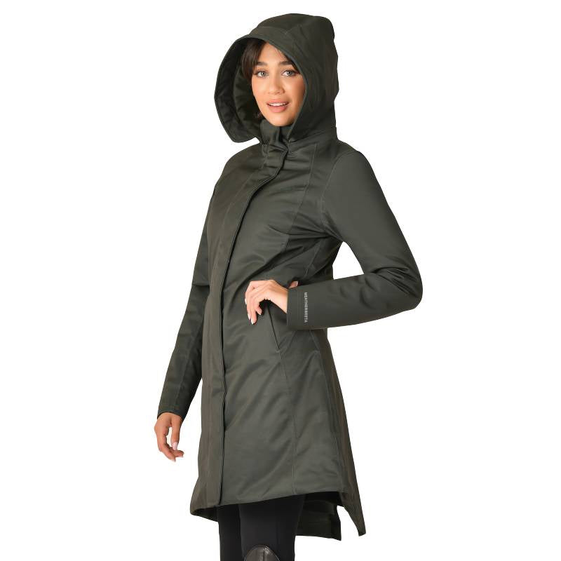 Woman wears a Weatherbeeta Midnight Green Waterproof Equestrian Jacket, standing and smiling.