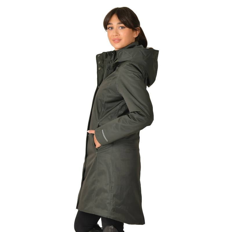 Woman in a Weatherbeeta All Purpose Waterproof Longline Equestrian Jacket in Midnight Green.