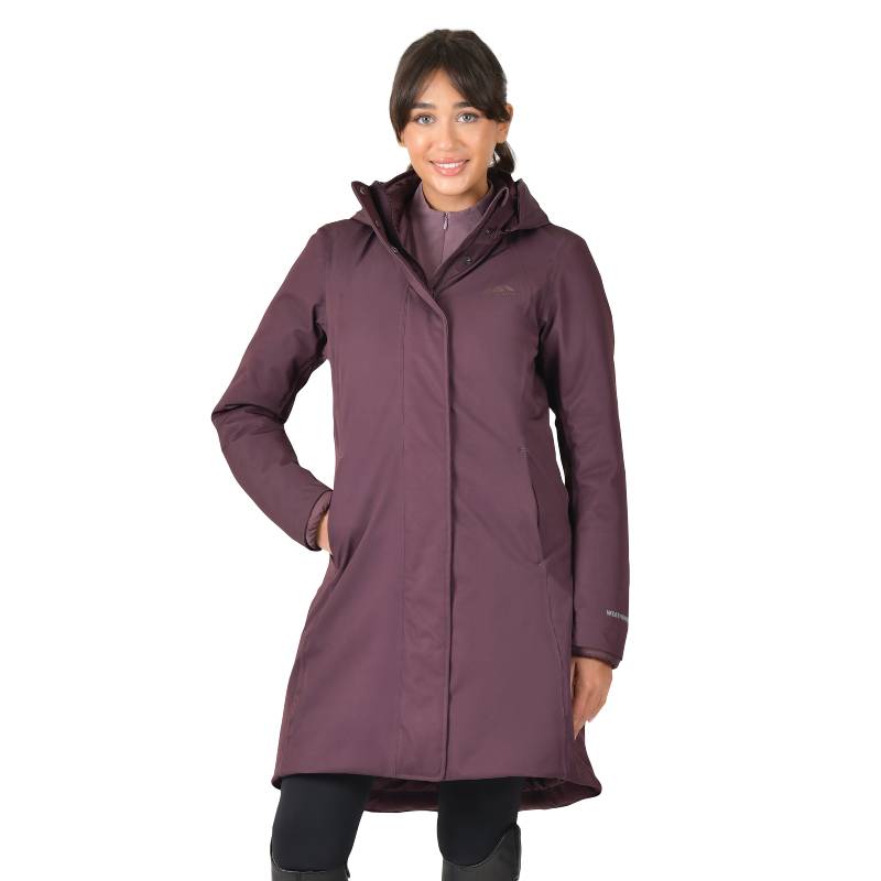 Woman wearing a Weatherbeeta All Purpose Waterproof Longline Equestrian Jacket in Mulberry.
