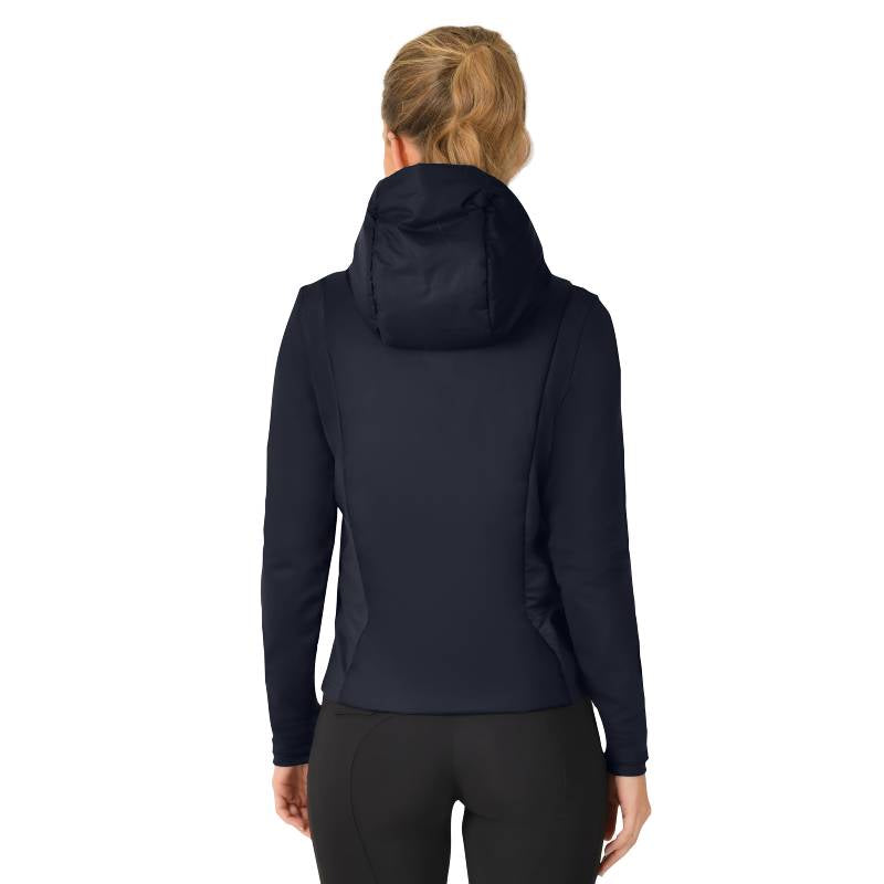 Woman in a Weatherbeeta Hybrid Padded Jacket Navy stands with hands clasped in front.