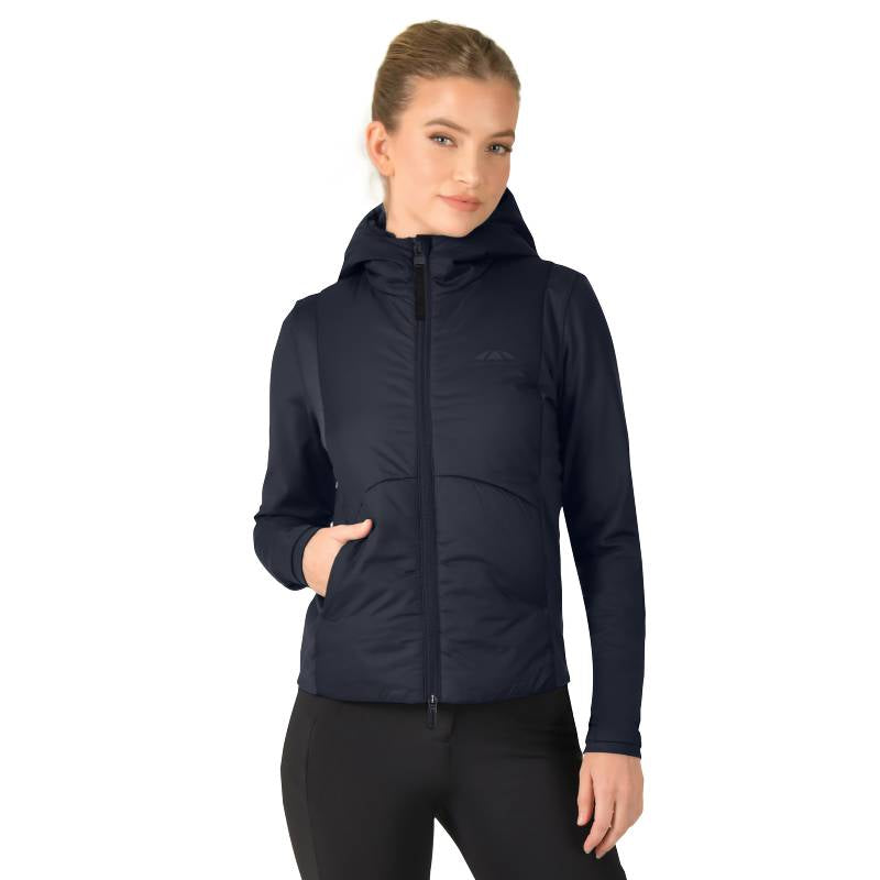 Woman in a Weatherbeeta Hybrid Padded Jacket Navy and black pants, hand in pocket.