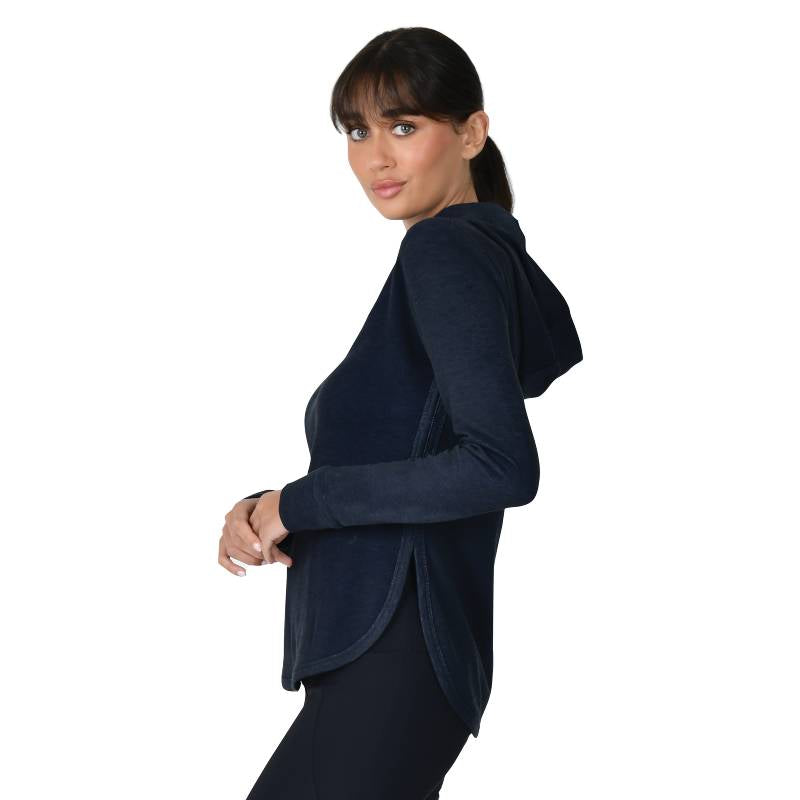 Woman in a Weatherbeeta London Layer navy hooded top, standing sideways against white background.