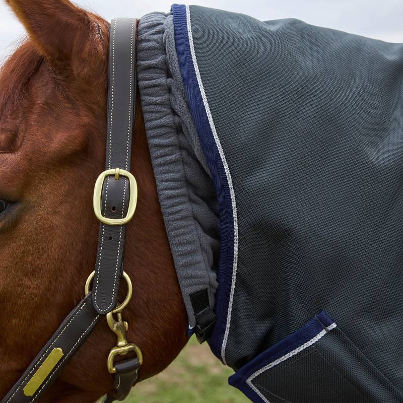 Close-up of a horse outdoors in a Weatherbeeta Ultra Turnout Rug 100g Charcoal and leather halter.