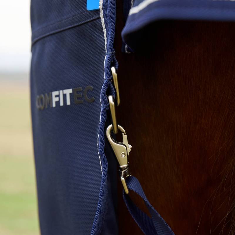 Close-up of a metal clasp on a navy Weatherbeeta Comfitec Ultra Detach-A-Neck turnout rug.