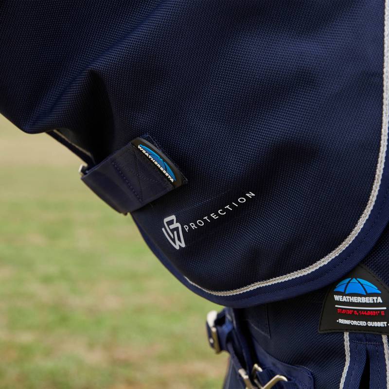 Close-up of a Weatherbeeta Comfitec Ultra Detach-A-Neck 100g Navy turnout rug with logo.
