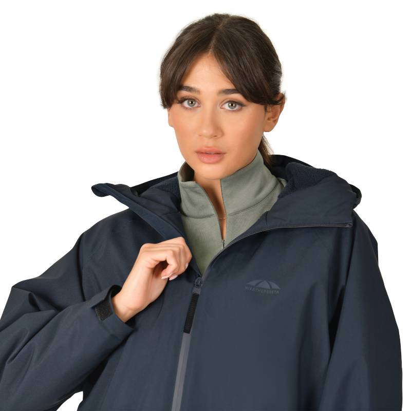 Woman in a Weatherbeeta All Weather Field Jacket Navy, hands in pockets, facing forward.