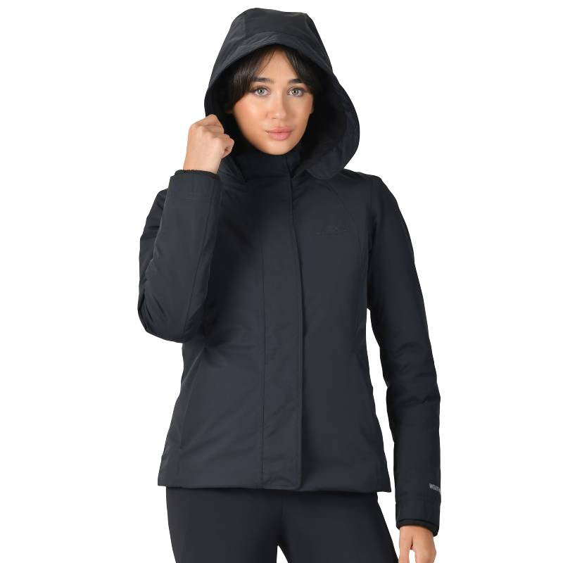 Woman wearing the Weatherbeeta Protect Jacket With High Neck Black, hand on her hip.