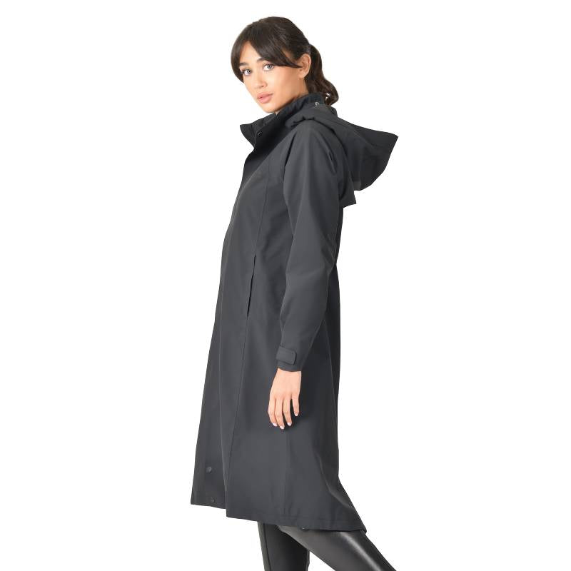 Woman in a Weatherbeeta Windbreaker Longline Riding Jacket Black stands sideways.