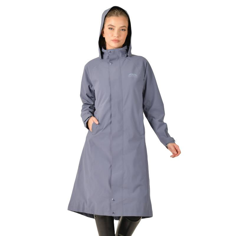 Woman in a Weatherbeeta Windbreaker Longline Riding Jacket in Slate Blue, hands in pockets.