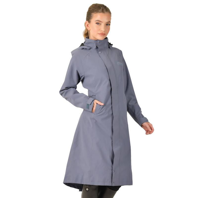 Woman wearing the Weatherbeeta Windbreaker Longline Riding Jacket in Slate Blue, hands in pockets.