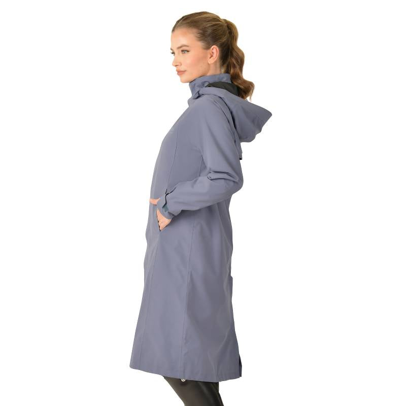 Woman in a Weatherbeeta Windbreaker Longline Riding Jacket Slate Blue, hands in pockets.