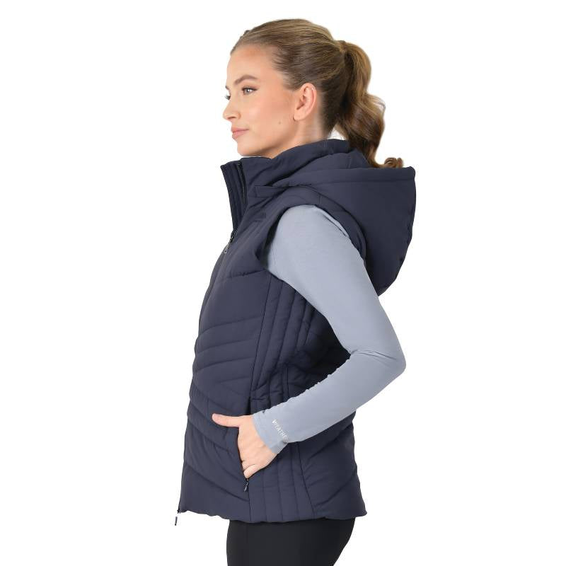 Woman in Weatherbeeta Insulated Vest Navy, gray long-sleeve shirt, standing in profile.
