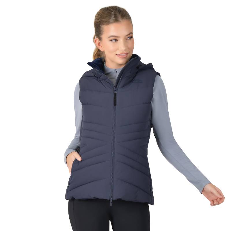 Woman in Weatherbeeta Insulated Vest Navy and gray long-sleeve shirt, standing sideways.