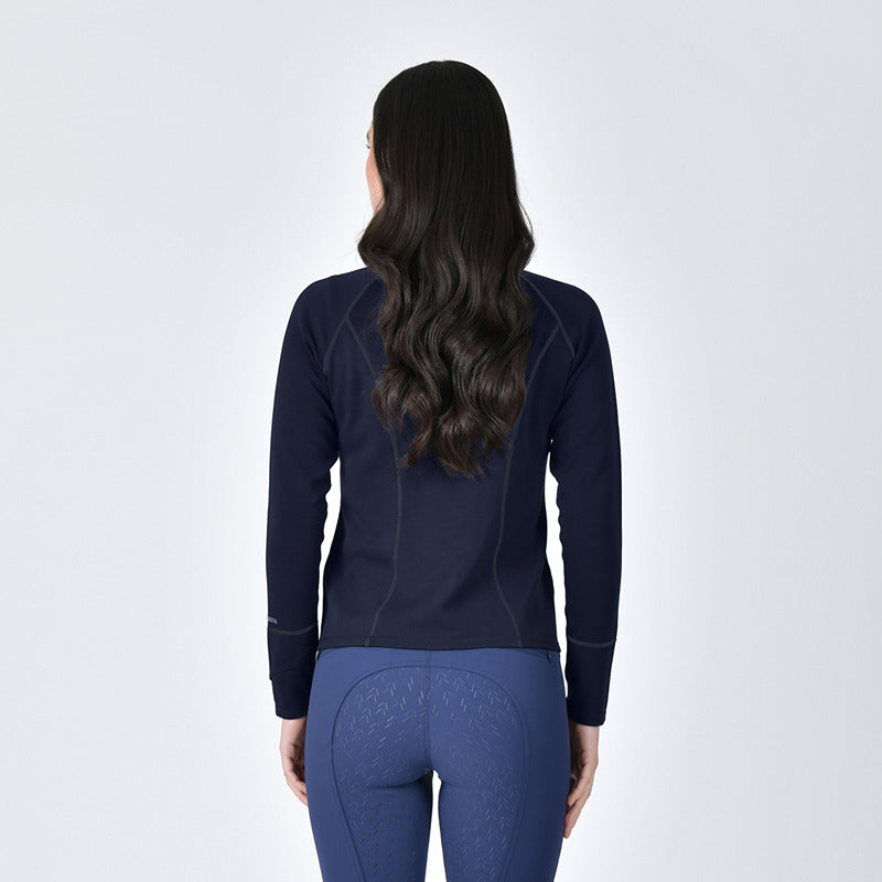Woman wearing a Weatherbeeta Copper Performance Jacket Navy and blue pants against a white background.