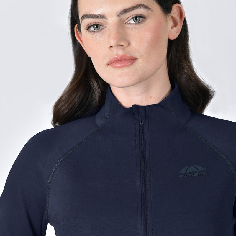 Woman wears Weatherbeeta Copper Performance Jacket Navy, facing forward on white background.