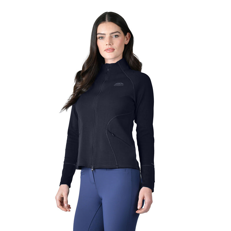 Woman wearing a Weatherbeeta Copper Performance Jacket Navy and blue pants against a white background.