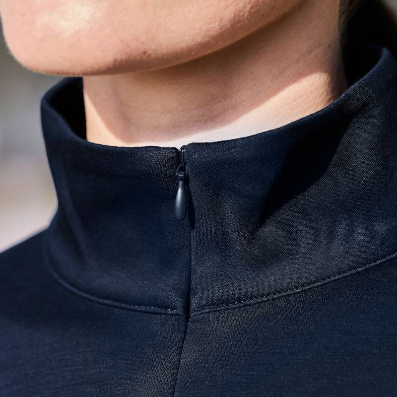Close-up of a person in the Weatherbeeta Copper 1/2 Zip Navy Long Sleeve Mid-Layer to the collar.