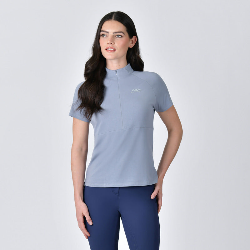 Woman wears Weatherbeeta Bamboo Blue Stone base layer and navy pants against a plain background.