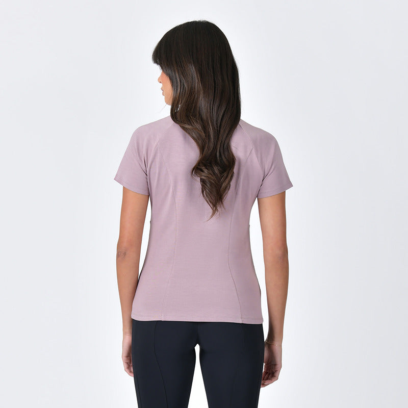 Woman in a Weatherbeeta Bamboo Base Layer Burnished Lilac and black pants faces away.