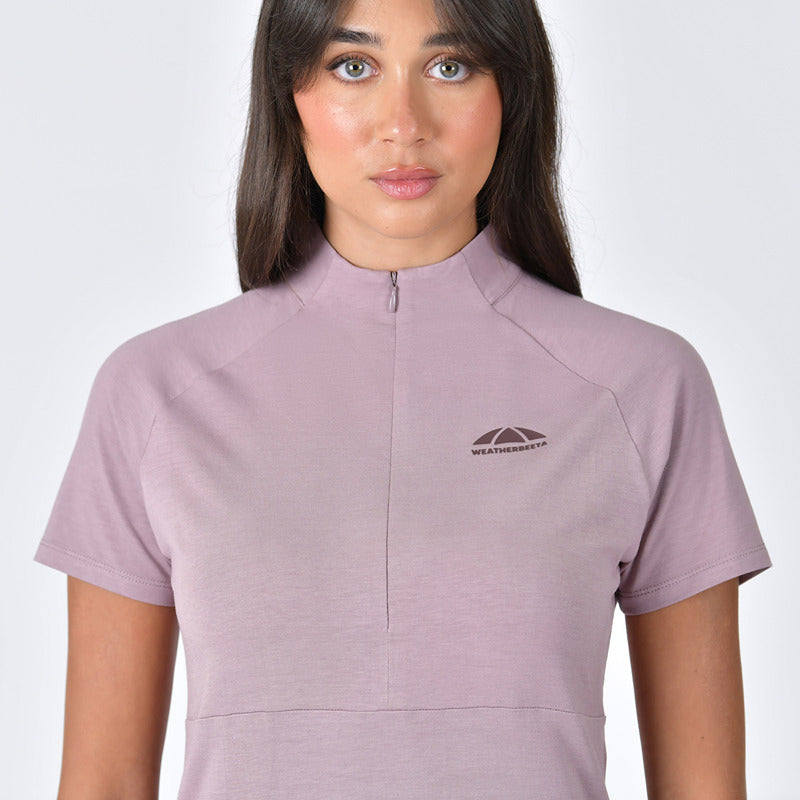 Woman in a Weatherbeeta Bamboo Short Sleeve Base Layer, Burnished Lilac, with front zipper.