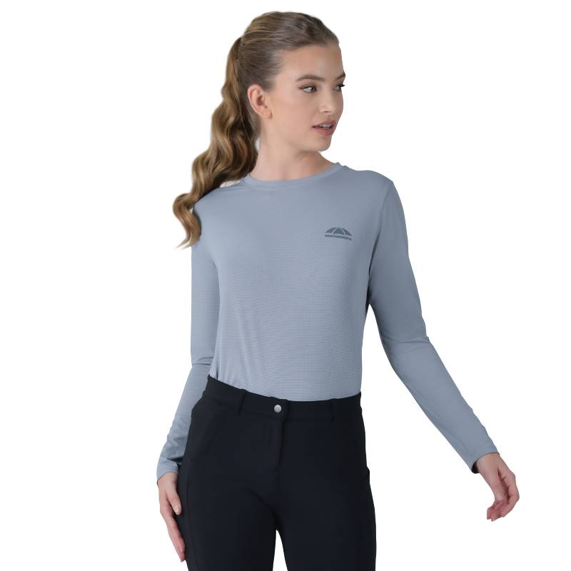 Woman in a Weatherbeeta Relaxed UV Long Sleeve Tee Blue Stone stands against a white background.