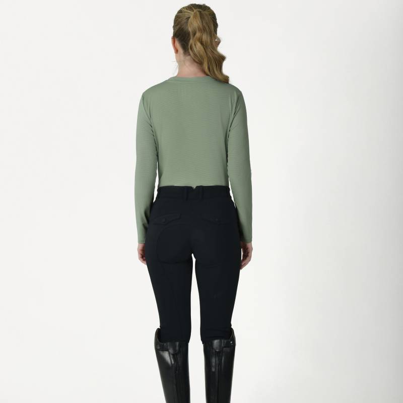Woman with long blonde hair in Weatherbeeta Relaxed UV Long Sleeve Tee Olive Leaf, black pants, boots.