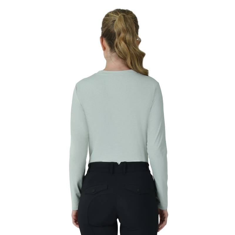 Woman in Weatherbeeta Relaxed UV Long Sleeve Tee Soft Sage and black pants against white background.