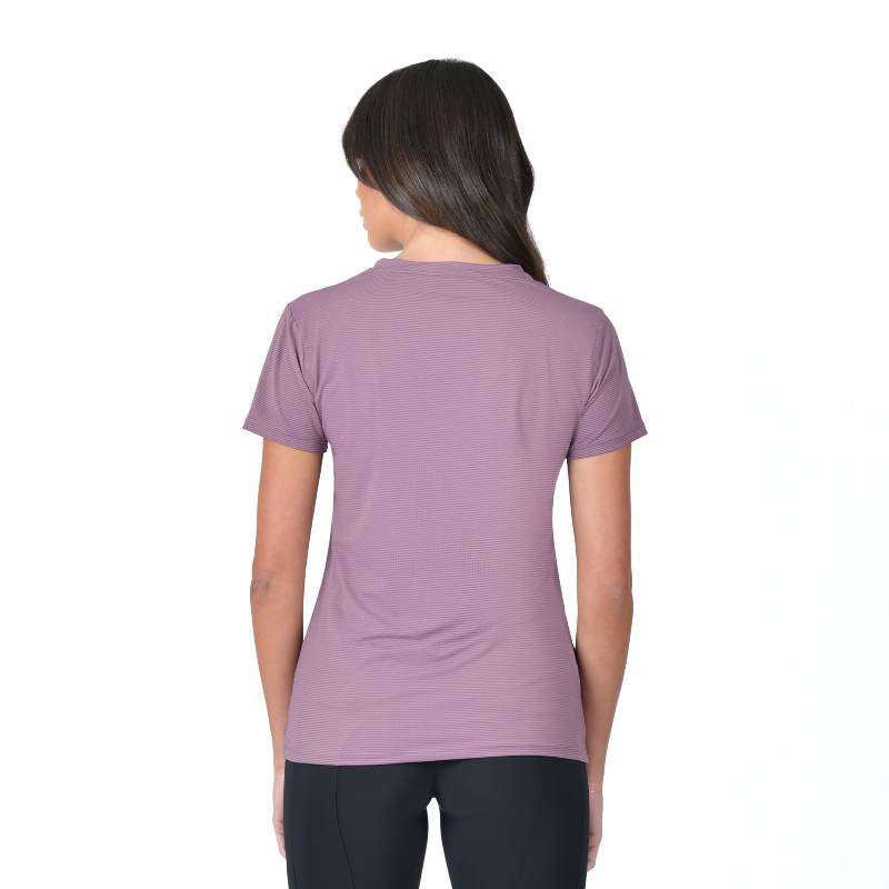 Woman poses, smiling, in a Weatherbeeta Relaxed UV Short Sleeve Tee Mauve Wine and black leggings.