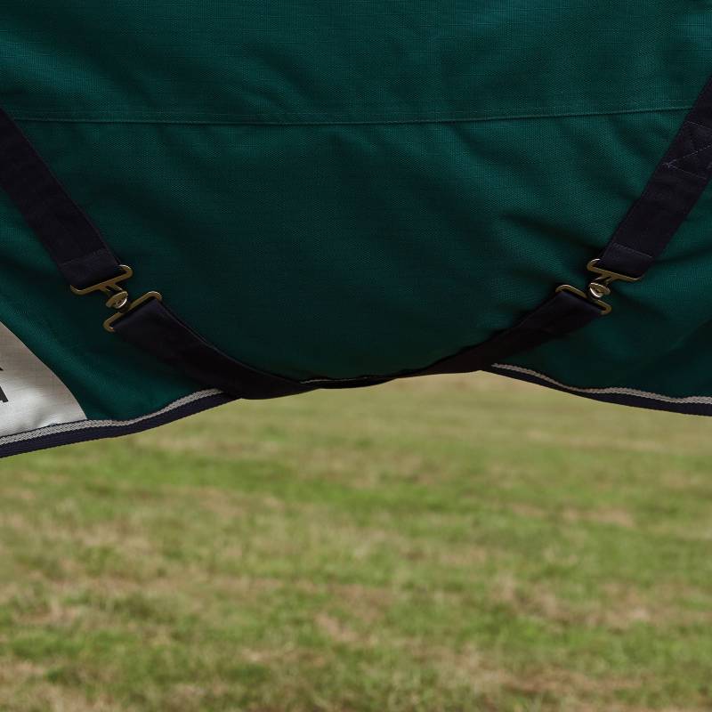 Close-up of green straps and buckles from a Weatherbeeta Comfitec Plus Dynamic 100g turnout rug.