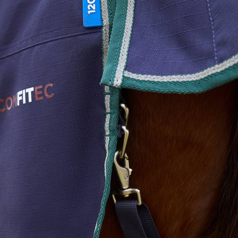 Weatherbeeta Comfitec Plus Dynamic rug in navy/forest green clasped onto a horse.